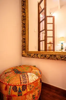 a mirror and a stool in a room at Romantic Maisonette in Chania Town