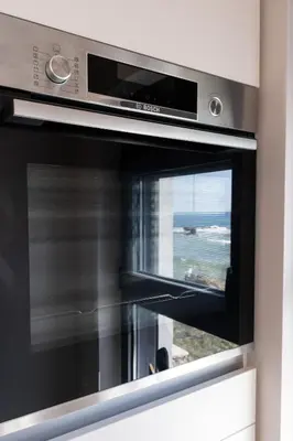 a microwave oven with a view of the ocean at Paradise for Couples, Next to Soothing Waves in Galatás