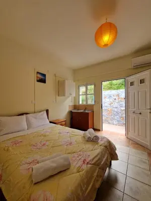 a bedroom with a bed with towels on it at Stefanos Garden2 in Arménoi