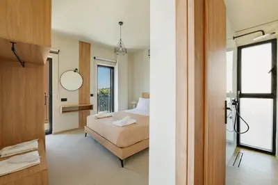 a bedroom with a bed and a bathroom at Madre Tierra Boutique Villa 1 in Liyidhés