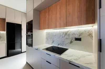 a kitchen with marble countertops and wooden cabinets at Madre Tierra Boutique Villa 1 in Liyidhés