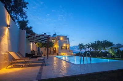 a house with a swimming pool at night at Villa Veghera in Kissamos