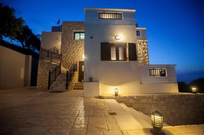 a large white building with a staircase leading up to it at Villa Veghera in Kissamos
