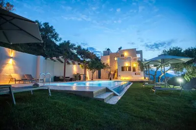 a backyard with a swimming pool and a house at Villa Veghera in Kissamos