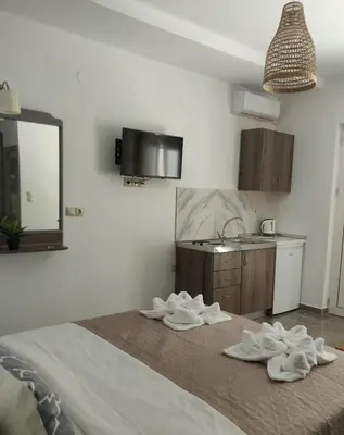 a bedroom with a bed with towels on it at Tile Apartments 3 in Agia Marina Nea Kydonias