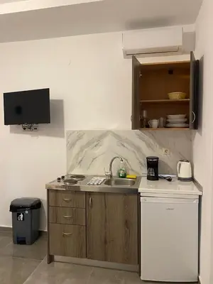 a kitchen with a sink and a counter top at Tile Apartments 3 in Agia Marina Nea Kydonias