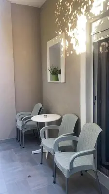 a row of chairs and tables in a room at Tile Apartments 3 in Agia Marina Nea Kydonias
