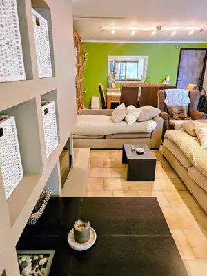 a living room with a couch and a table at Zen House with Fairytale Garden & Sea View in Daratso