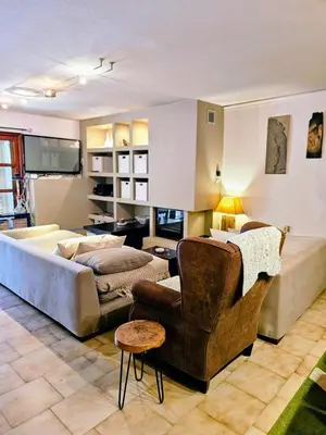 a living room with a bed and a chair at Zen House with Fairytale Garden & Sea View in Daratso