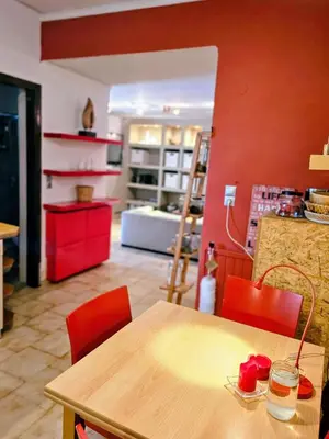 a kitchen with a wooden table and red chairs at Zen House with Fairytale Garden & Sea View in Daratso
