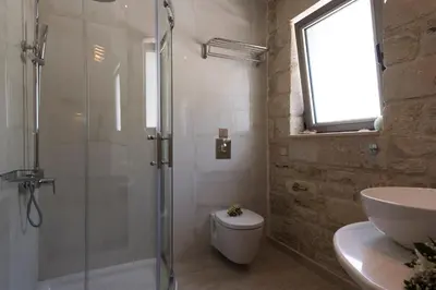a bathroom with a shower and a toilet and a sink at Libyan Mare in Palaiochóra
