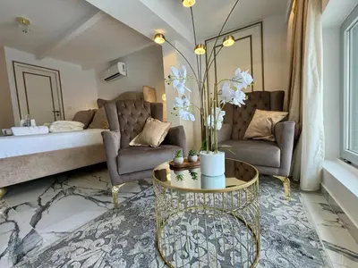 a living room with a bed and a table at Mare suites 3 in Chania Town