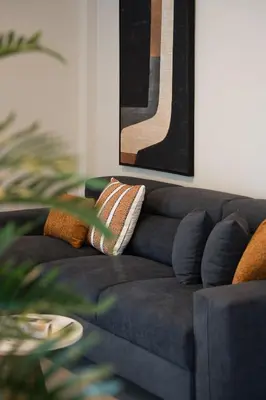 a blue couch with pillows in a living room at Nea Chora Boutique Apartment in Chania Town