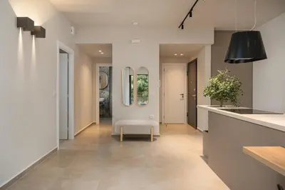 a hallway of a home with a chair in it at Nea Chora Boutique Apartment in Chania Town