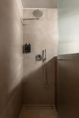 a shower with a shower head in a bathroom at Nea Chora Boutique Apartment in Chania Town