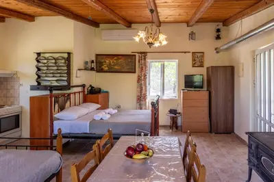 a room with two beds and a table with fruit on it at Nicola's House in Tsivarás