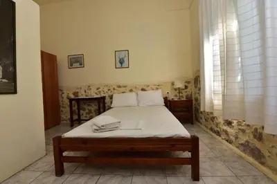 a bedroom with a bed in a room at Anonymous Homestay in Palaiochóra
