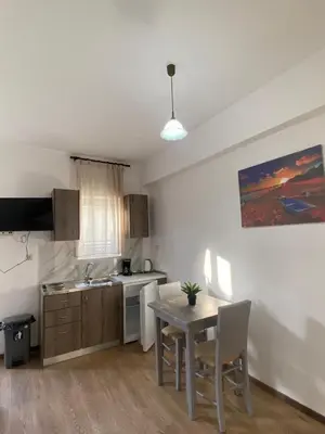 a kitchen with a table and a dining room at Tile Apartments 4 in Agia Marina Nea Kydonias