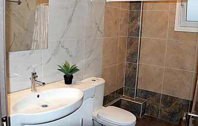a bathroom with a sink and a toilet at Tile Apartments 4 in Agia Marina Nea Kydonias
