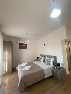 a bedroom with a large bed in a room at Tile Apartments 5 in Agia Marina Nea Kydonias