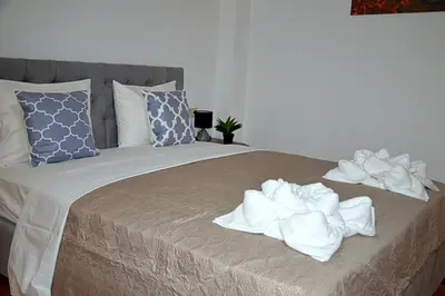 a bed with white towels on top of it at Tile Apartments 6 in Agia Marina Nea Kydonias