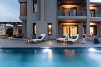 a house with a swimming pool in front of a building at Calmar Boutique Villa 5min drive to Kolymvari beach with Private Pool & Sea Views in Kolymvari