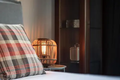 a lamp sitting on a bed next to a pillow at Calmar Boutique Villa 5min drive to Kolymvari beach with Private Pool & Sea Views in Kolymvari