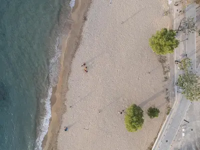 an overhead view of a beach with a group of people at Neachora Beachfront Suites in Chania Town
