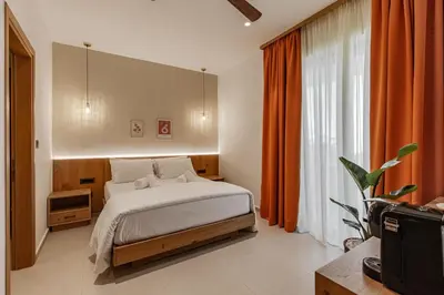 a bedroom with a bed and a large window at Sarana Suites Crete in Kissamos