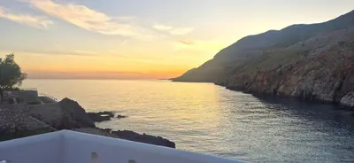 a view of a body of water at sunset at Sfakia On the Beach in Khóra Sfakíon