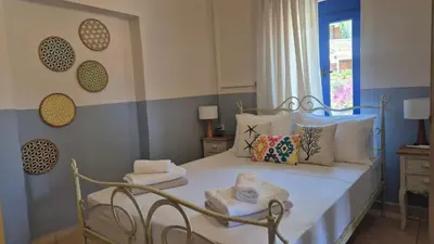 a bedroom with a bed with towels on it at Sfakia On the Beach in Khóra Sfakíon