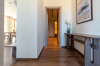 a hallway with a table and a dining room at Pallazzo Dei Miracoli - Luxe 3BR apt Sea & Old Port Terrace View in Chania Town