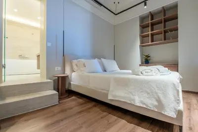 a bedroom with a bed with towels on it at Pallazzo Dei Miracoli - Luxe 3BR apt Sea & Old Port Terrace View in Chania Town