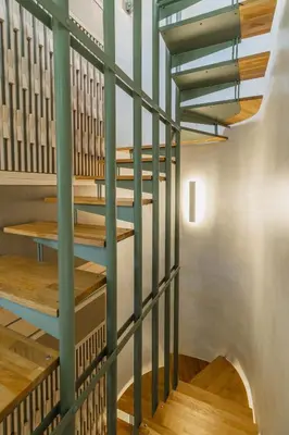 a staircase with green railings in a building at Panaretos Deluxe Maisonette in Chania Town