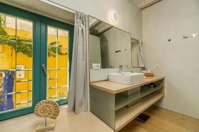 a bathroom with a sink and a mirror at Panaretos Deluxe Maisonette in Chania Town