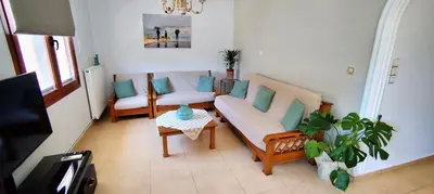 a living room with a couch and chairs and a table at La Casa di Teta by superhosthub in Galatás
