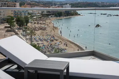 a balcony with a view of a beach at EdgeWater Beach Hotel in Chania Town