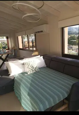a living room with a couch and pillows on it at Angela Home, 5Street, Perivolia in Perivólia
