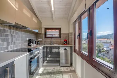 a kitchen with a sink and a large window at Angela Home, 5Street, Perivolia in Perivólia