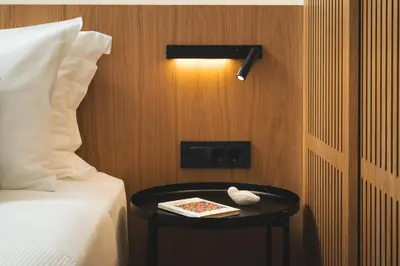 a room with a bed and a table with a book on it at Kydoni Signature Apartment in Chania Town