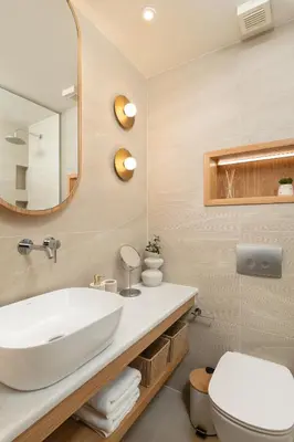 a bathroom with a white sink and a mirror at Kydoni Signature Apartment in Chania Town