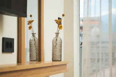 three vases sitting on a shelf with flowers in them at Kydoni Signature Apartment in Chania Town