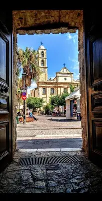 a view of a building from an open door at Serenity Apartment Chania City Centre in Chania Town