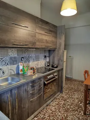 a kitchen with a sink and a stove top oven at Serenity Apartment Chania City Centre in Chania Town