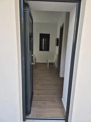 a hallway leading to a room with a table at Aldea Apartments in Módhion