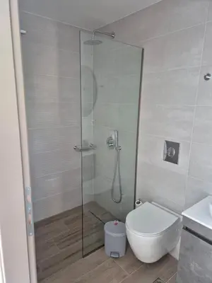 a bathroom with a shower with a toilet and a sink at Aldea Apartments in Módhion