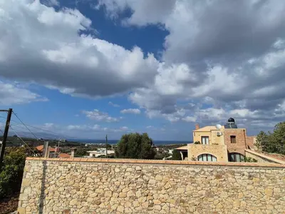 a stone wall in front of a building at Aldea Apartments in Módhion