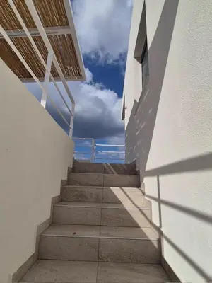 a staircase leading up to a building with the sky in the background at Aldea Apartments in Módhion