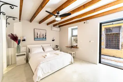 a bedroom with a large bed and a window at Amy's Little Gem in Chania Town
