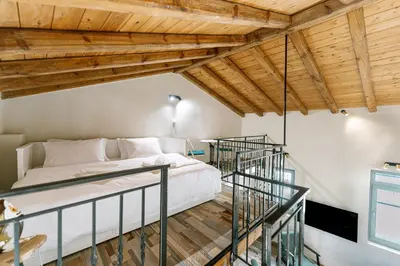 a bedroom with a bed and wooden ceilings at Amy's Little Gem in Chania Town